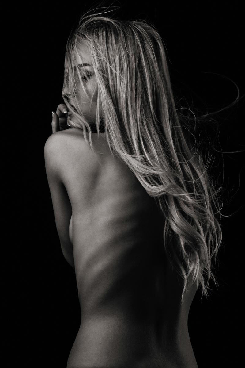 Woman photographed from behind in black and white