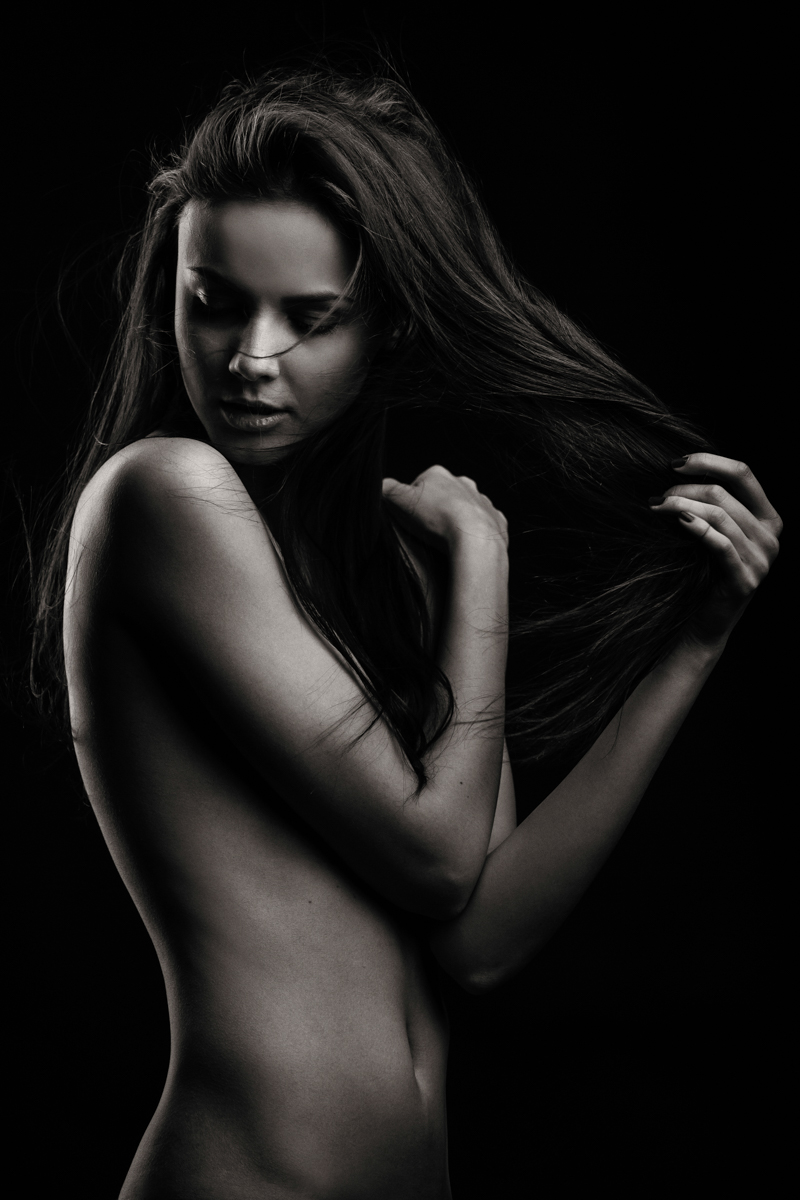 Black-and-white portrait of a woman against darkness
