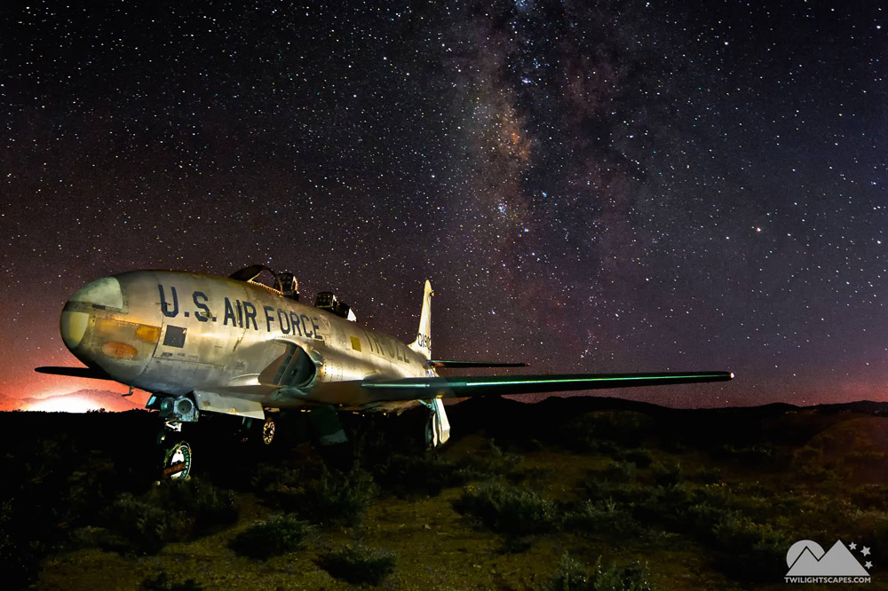 Aircraft marked U.S. Air Force beneath a starry sky with the Milky Way visible above