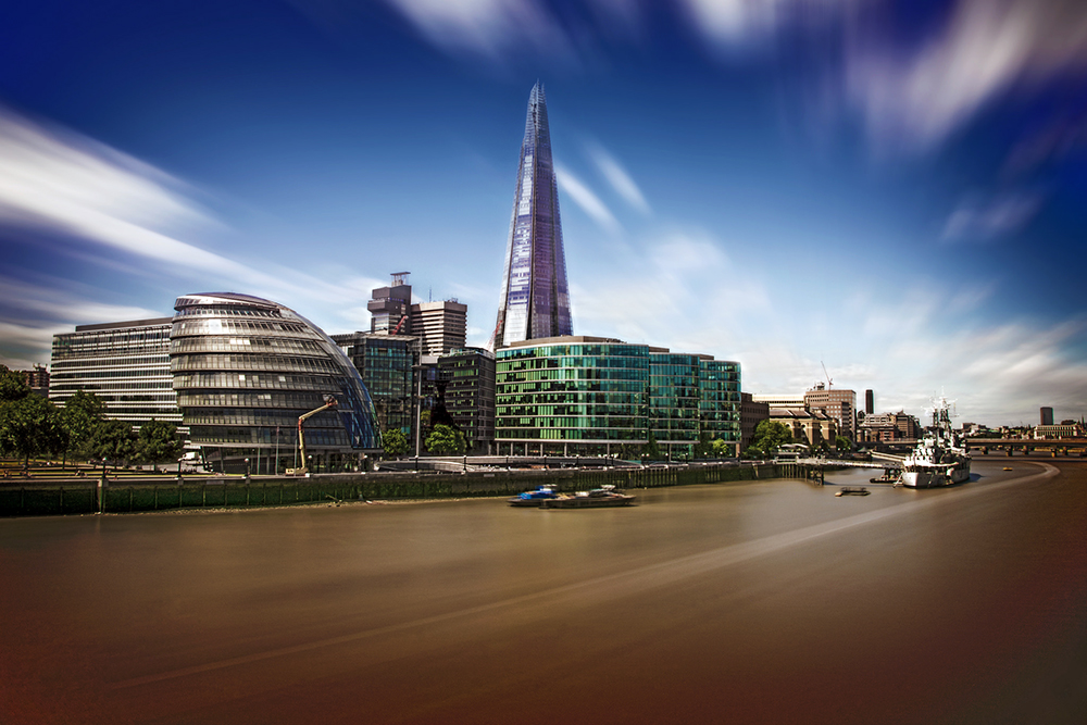 Long-exposure view from Tower Bridge with a riverboat trail - London by Huseyin Faik