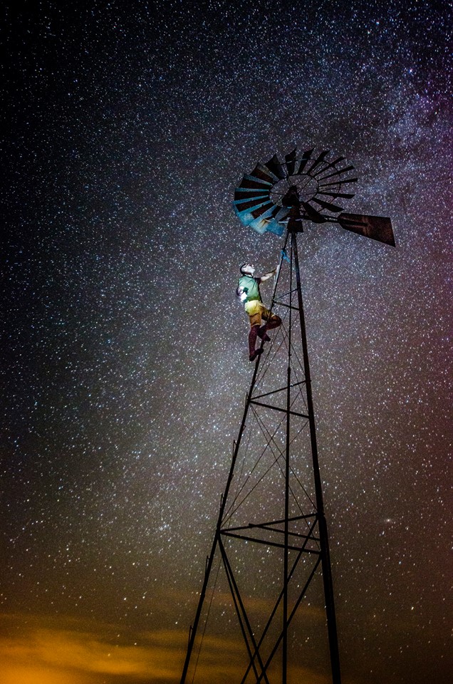 Climber on a windmill under the Milky Way - astrophotography by Joao Santos