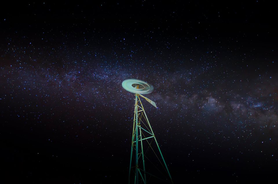 Illuminated tower structure under the Milky Way - astrophotography by Joao Santos