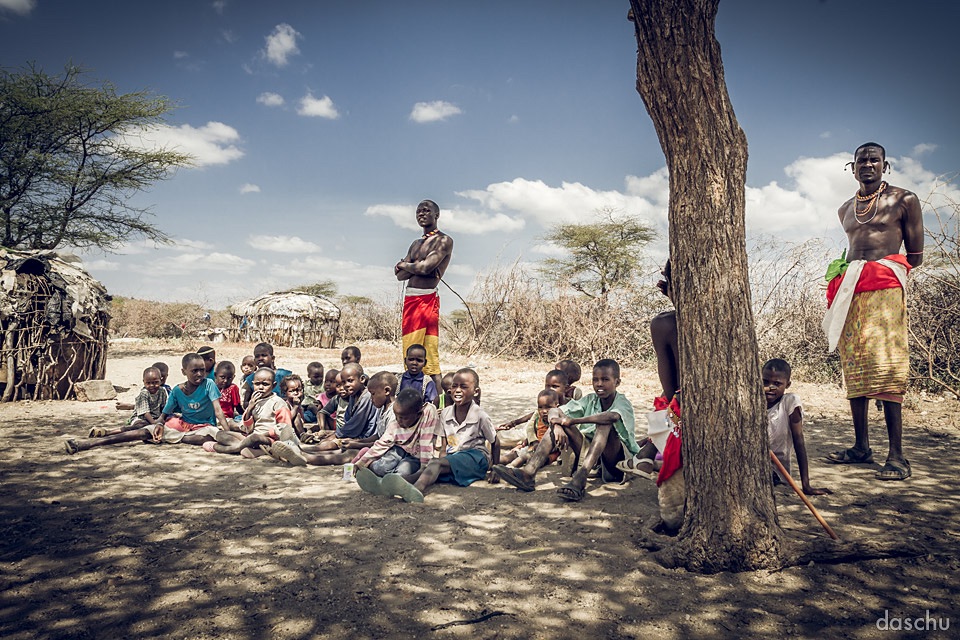 Samburu children seated in the shade of a tree - Daniel Schuhmacher