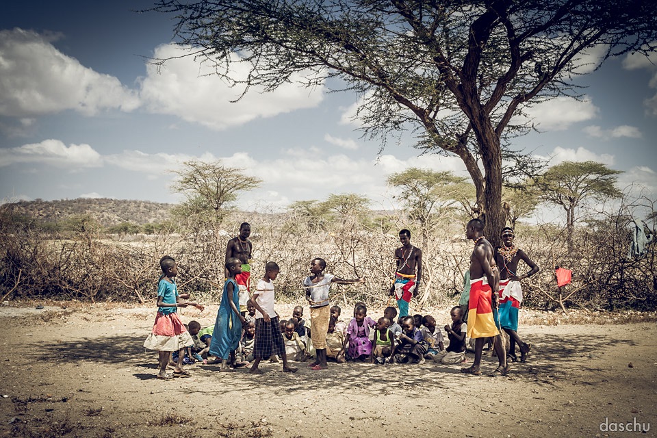 Samburu villagers gathered under an acacia tree - Daniel Schuhmacher