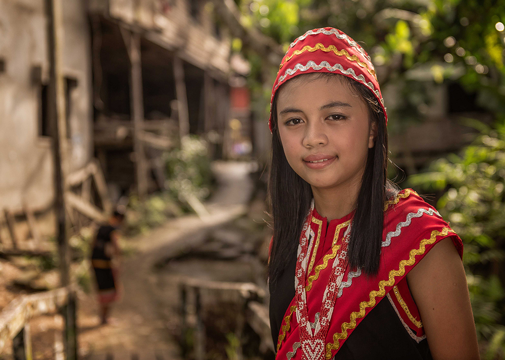 Bidayuh girl in traditional red dress and beadwork hat - The Native of Sarawak by Edanan Taiban