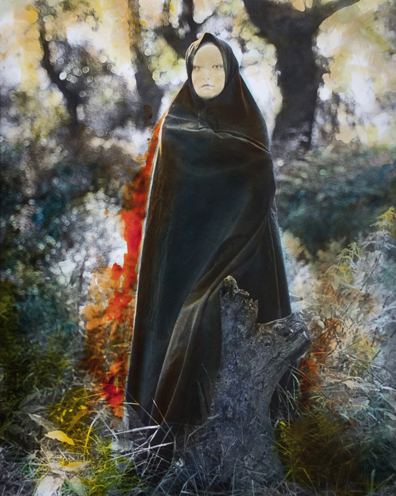 Dark wrapped figure with a pale face standing among mottled green, gold, and gray textures