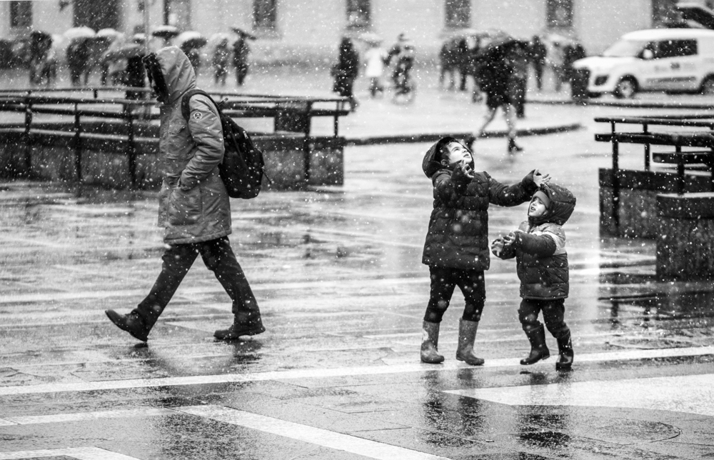 Man and child crossing a rainy street - Rain by Marco Gaia