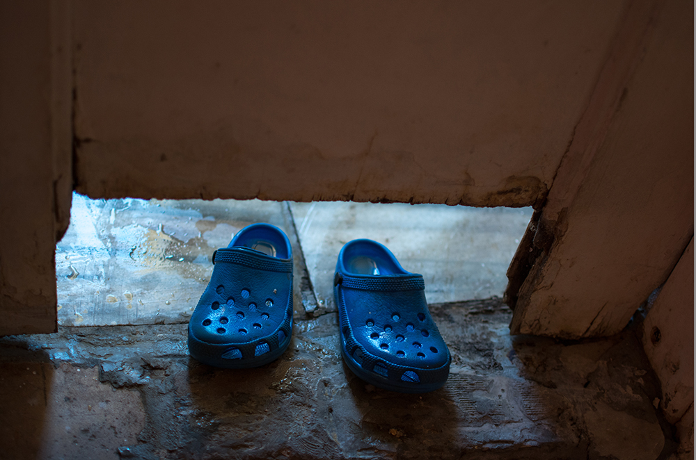 Blue shoes at a doorstep - The Unblinking Eyes by Nensi Bogdani