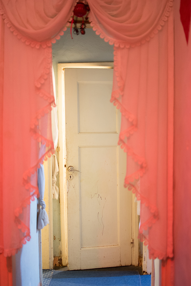 Pink-curtained doorway in an Athens squat - The Unblinking Eyes by Nensi Bogdani