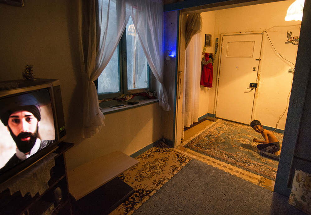 Television and hallway in a refugee home, Athens - The Unblinking Eyes by Nensi Bogdani