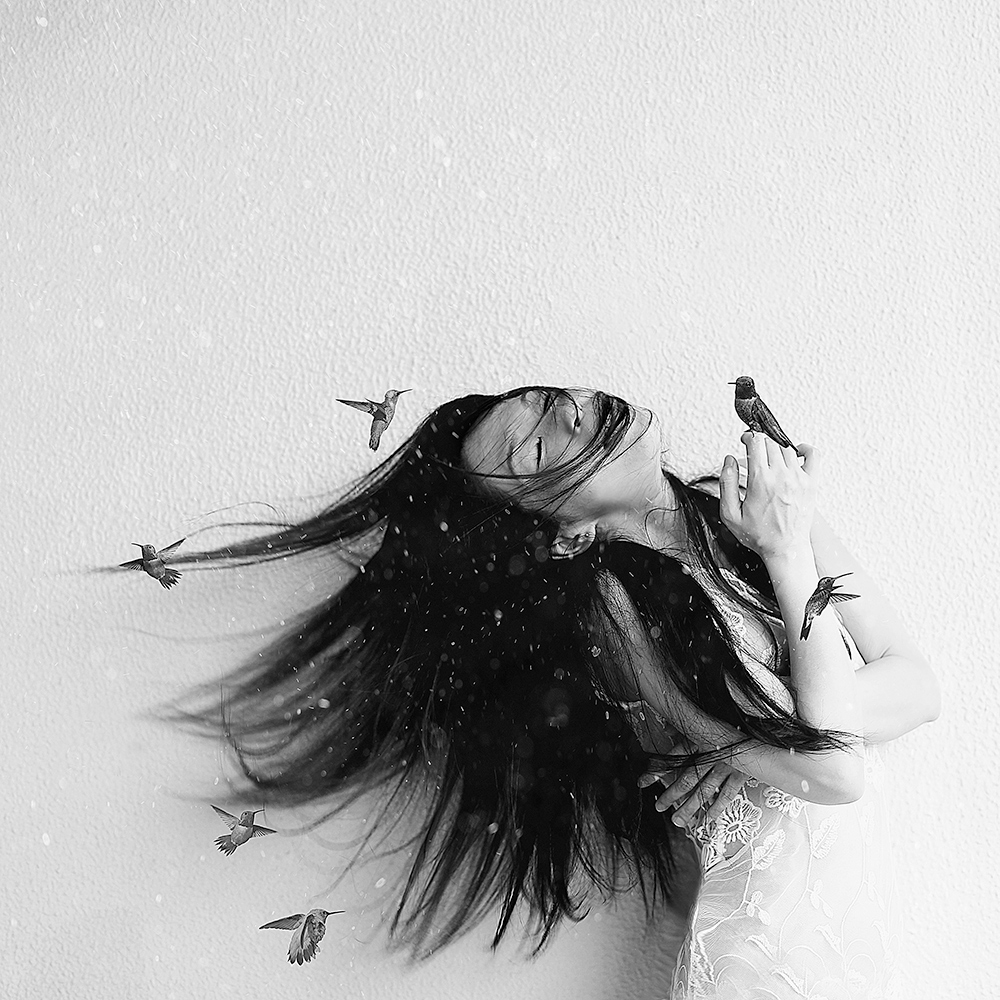Woman with her hair flying into birds - surreal photo by Cathryn Mok