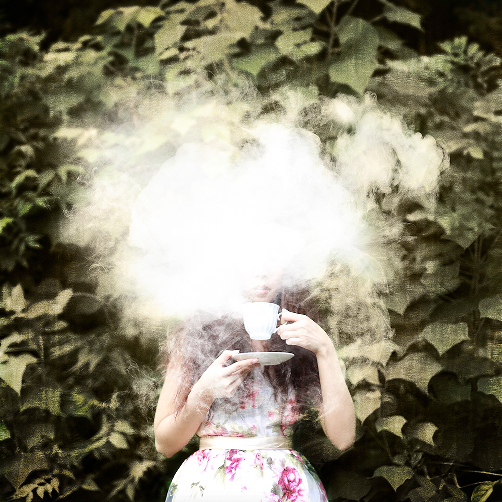 Girl holding a glowing cloud in the forest - surreal photo by Cathryn Mok