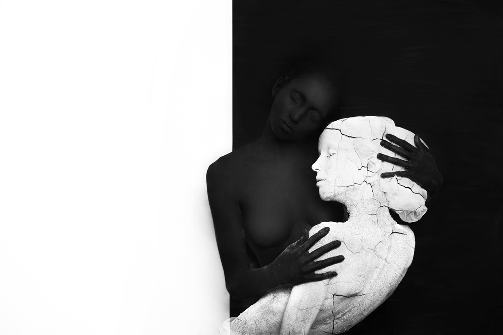 Embracing couple in black and white body paint - Metamorphosis Black Butterfly by Olga Volodina
