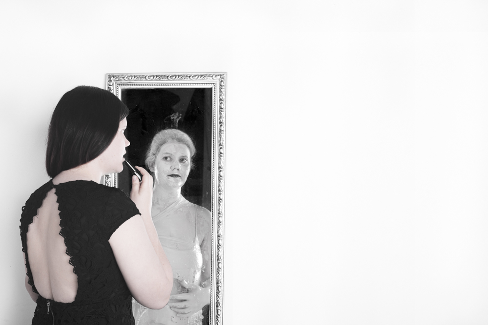 Woman in black facing her porcelain-white reflection in a mirror - Fading away, depression series by Cheree Smith