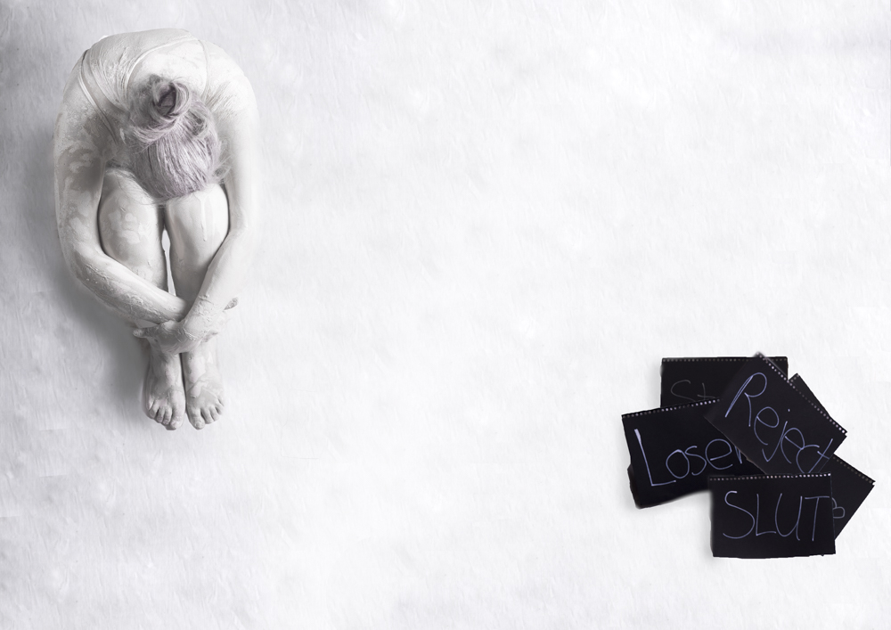 Curled porcelain figure beside hand-lettered cards - Fading away, depression series by Cheree Smith