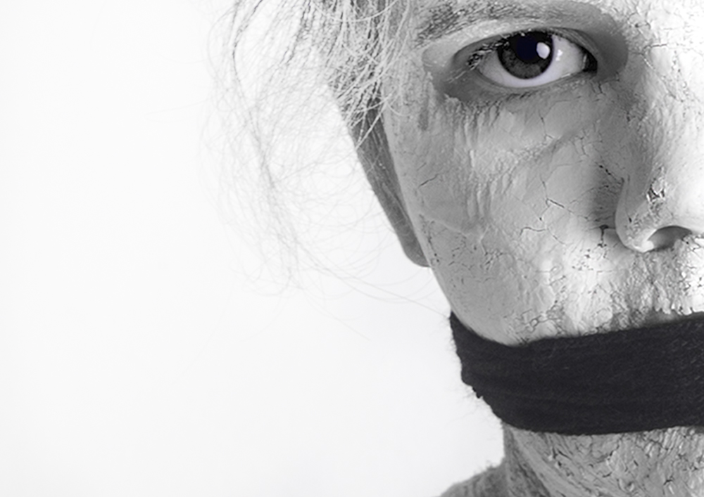 Porcelain-cracked face with a black band over the mouth - Fading away, depression series by Cheree Smith