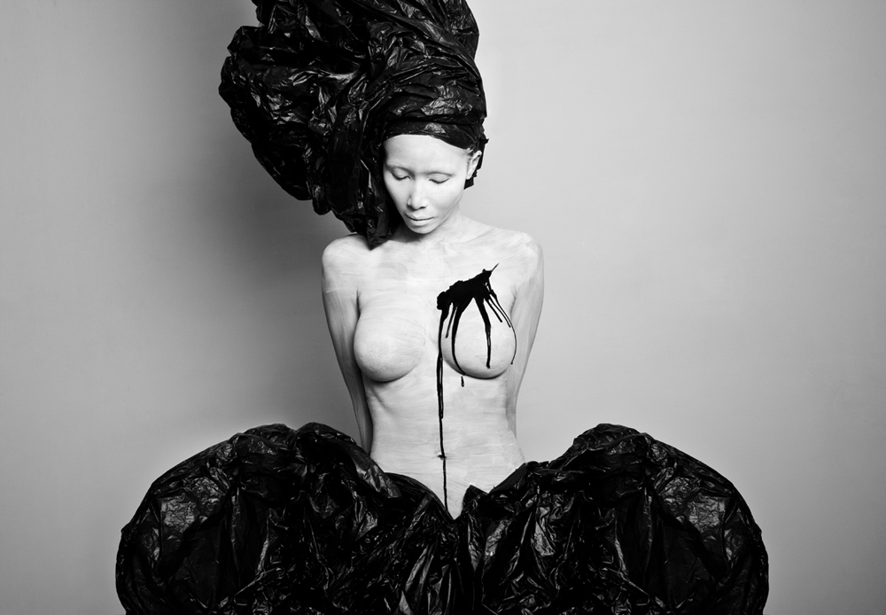 Woman with a sculptural black headdress and bow - Metamorphosis Black Butterfly by Olga Volodina