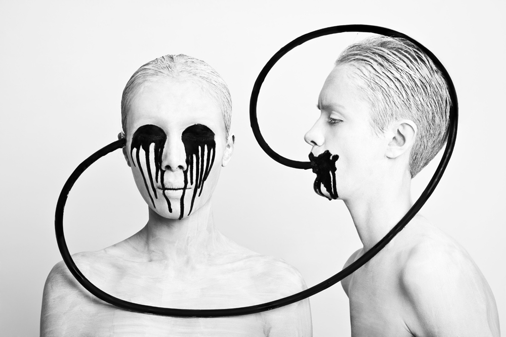 Two painted figures joined by a black circle - Metamorphosis Black Butterfly by Olga Volodina