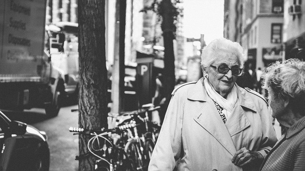 Two elderly women talking on a tree-lined sidewalk - New Yorkers by Lebrvn Creations