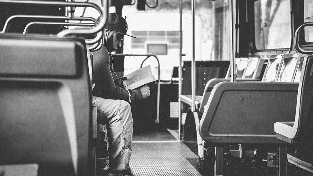 Man reading a newspaper on a city bus - New Yorkers by Lebrvn Creations