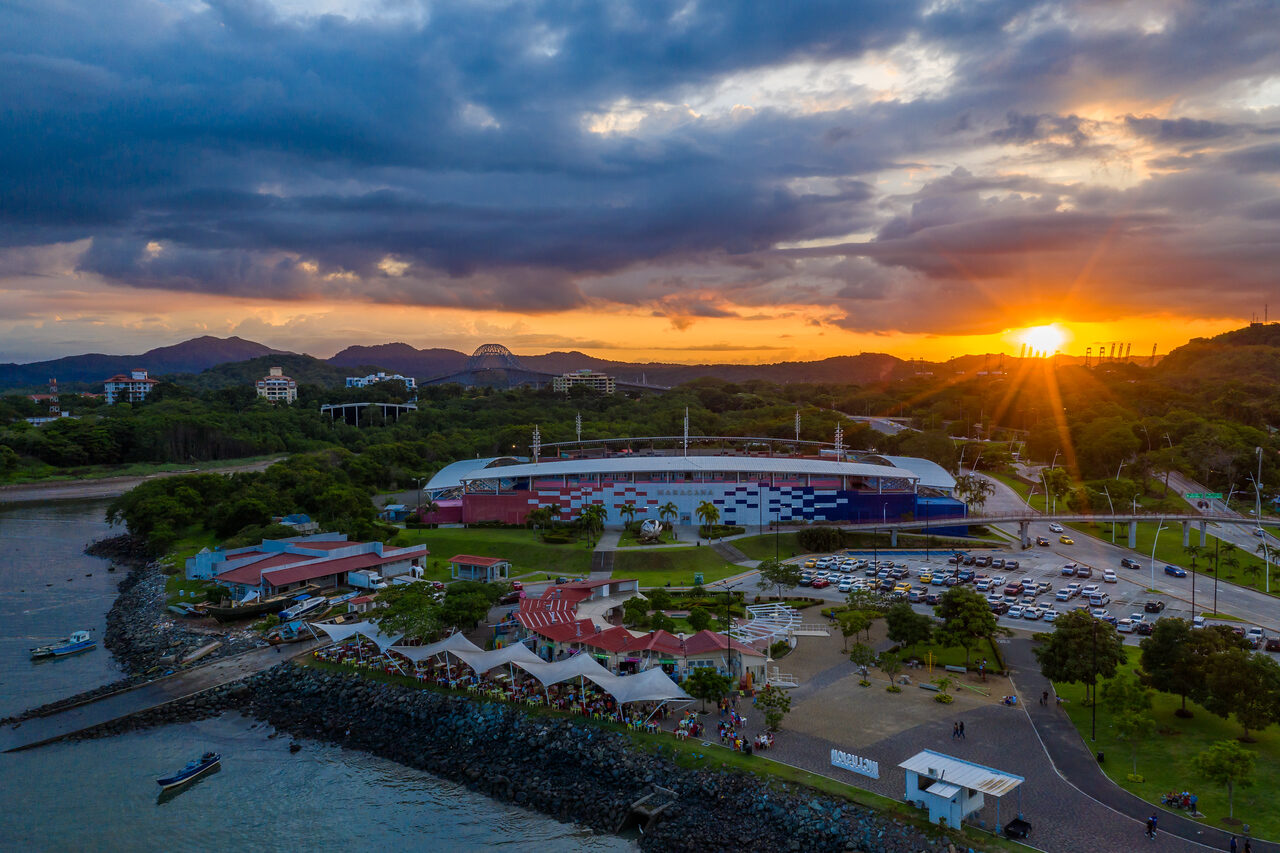 Sunset over Panama City's waterfront, buildings, and distant hills