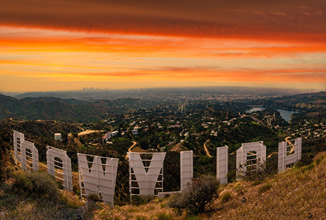 Hollywood Sign seen from behind at sunset overlooking Los Angeles