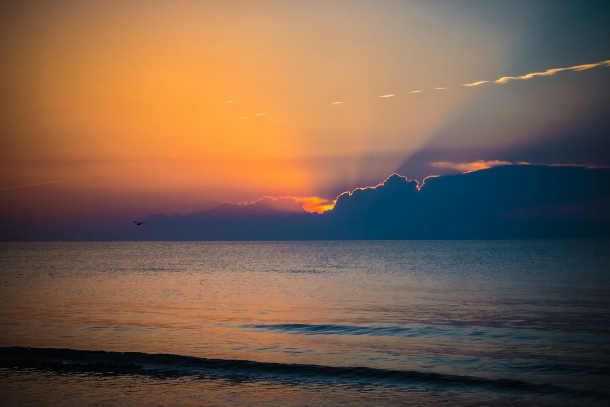 Golden sunrise over a calm Black Sea shoreline in Mamaia, Romania