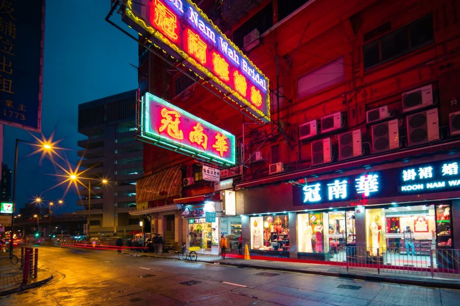 Neon signs lighting a wet Hong Kong street at night