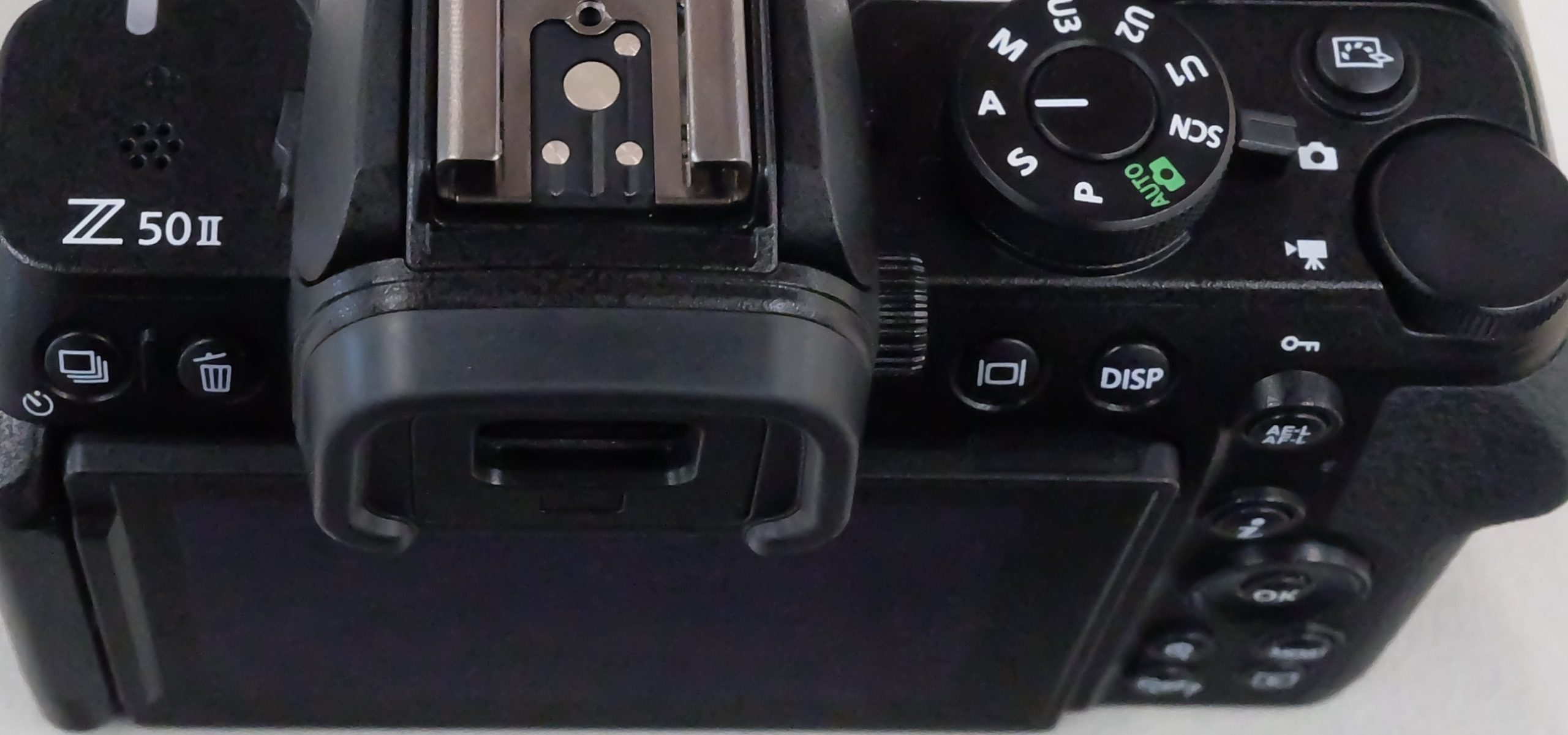 Nikon Z50II top and rear controls, mode dial and model label, tightly cropped