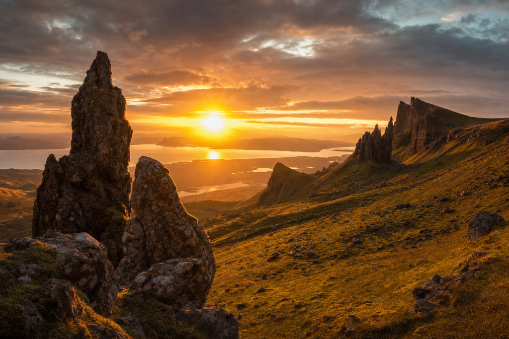 Dramatic landscape at golden hour with leading lines, foreground interest, warm directional light, photorealistic