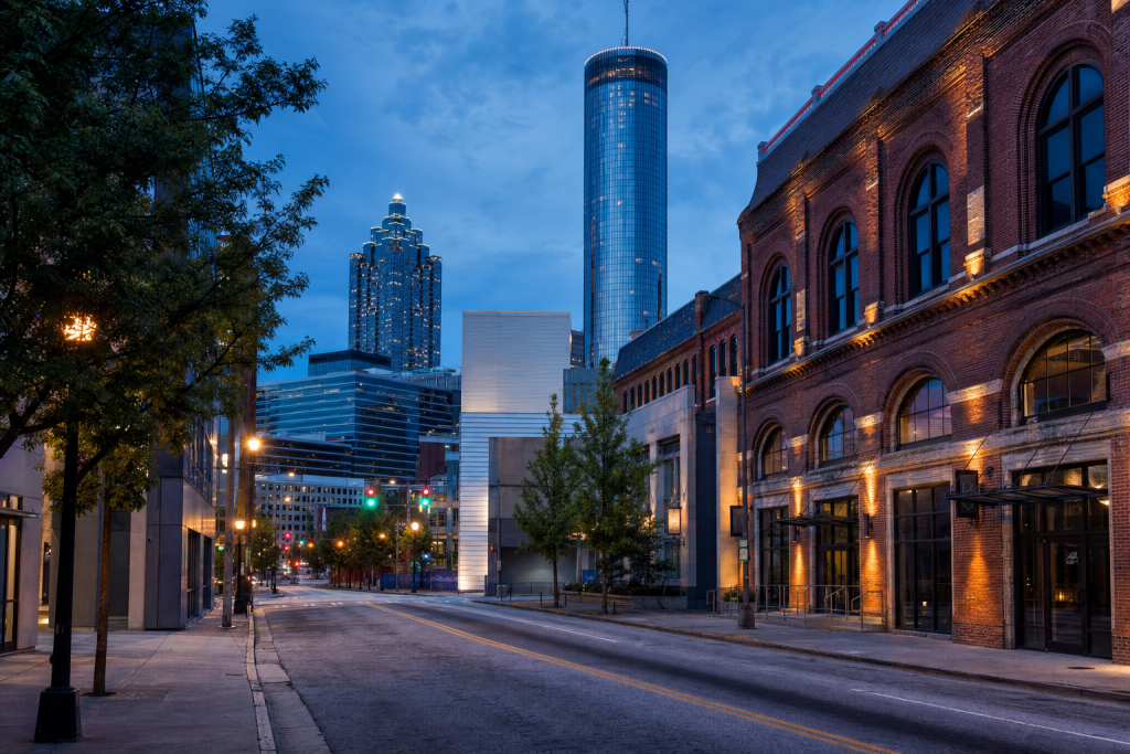 Street-level perspective in Atlanta, leading lines, architectural detail, blue hour with mixed ambient and street lighting