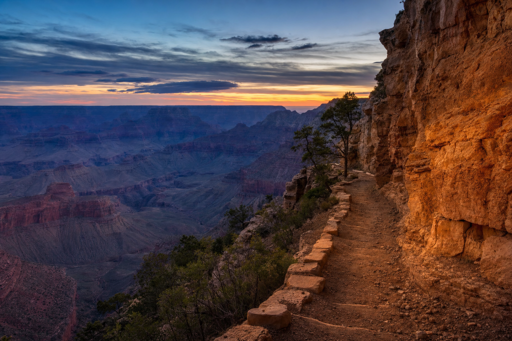 Street-level perspective in Grand Canyon, leading lines, architectural detail, blue hour with mixed ambient and street