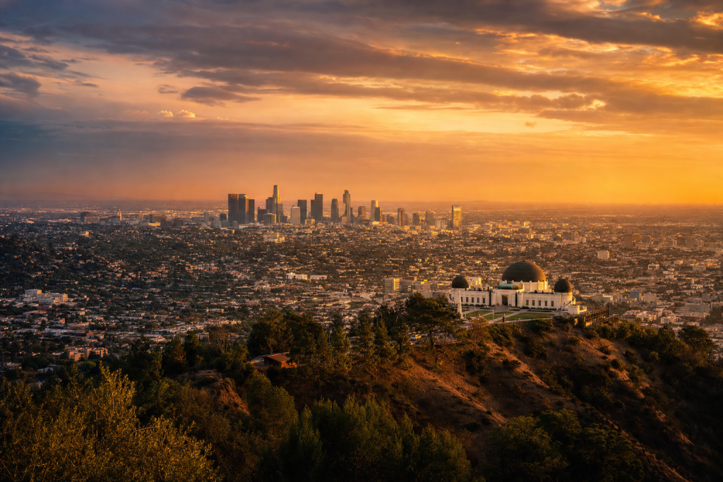 Los Angeles at golden hour, iconic landmarks visible, dramatic warm light