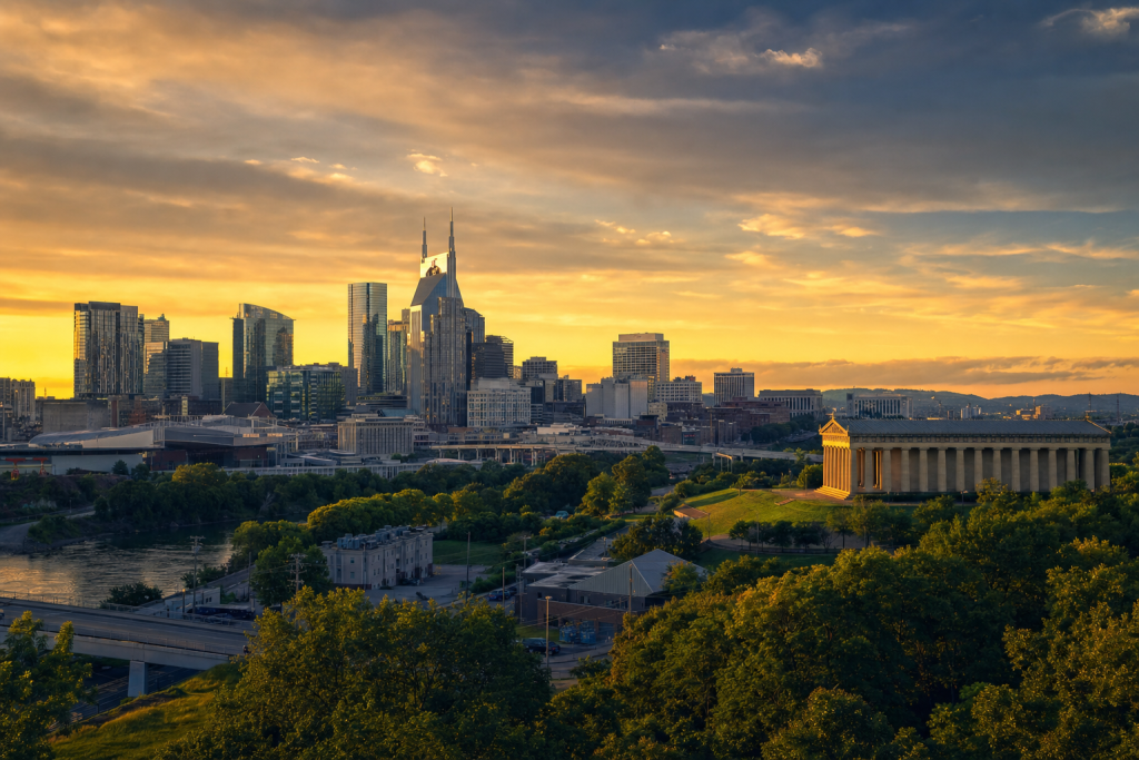 Wide-angle cinematic skyline of Nashville at golden hour, iconic landmarks visible, dramatic warm light