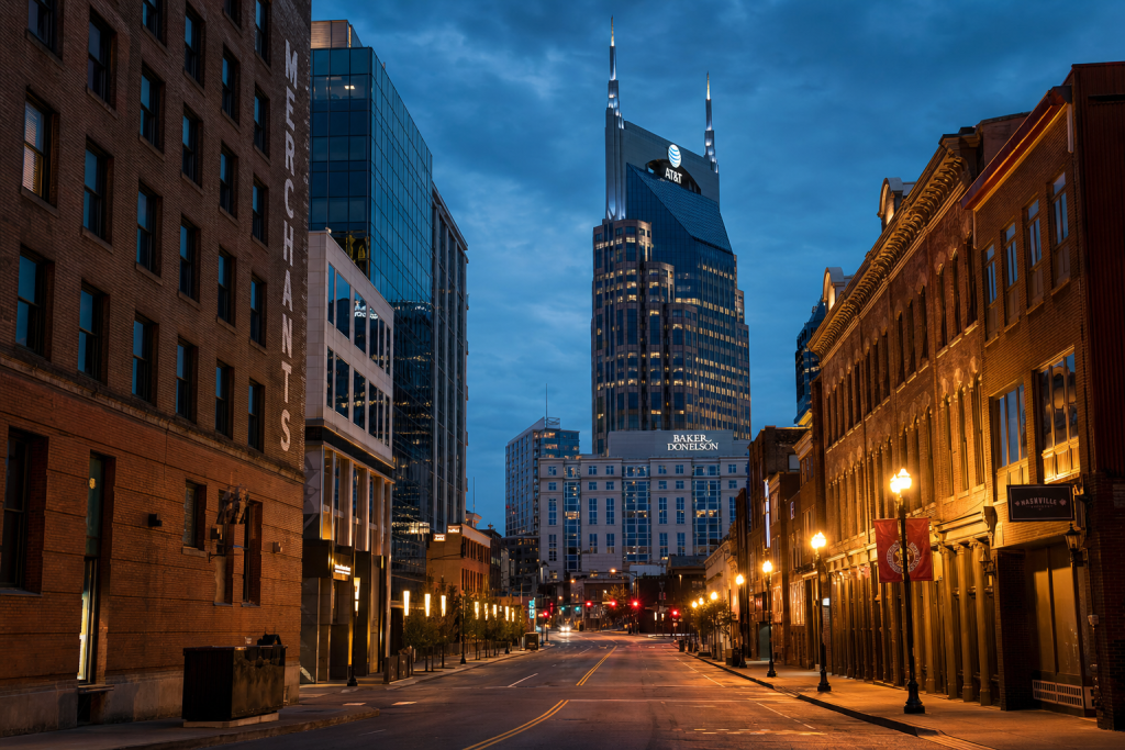 Street-level perspective in Nashville, leading lines, architectural detail, blue hour with mixed ambient and street lighting