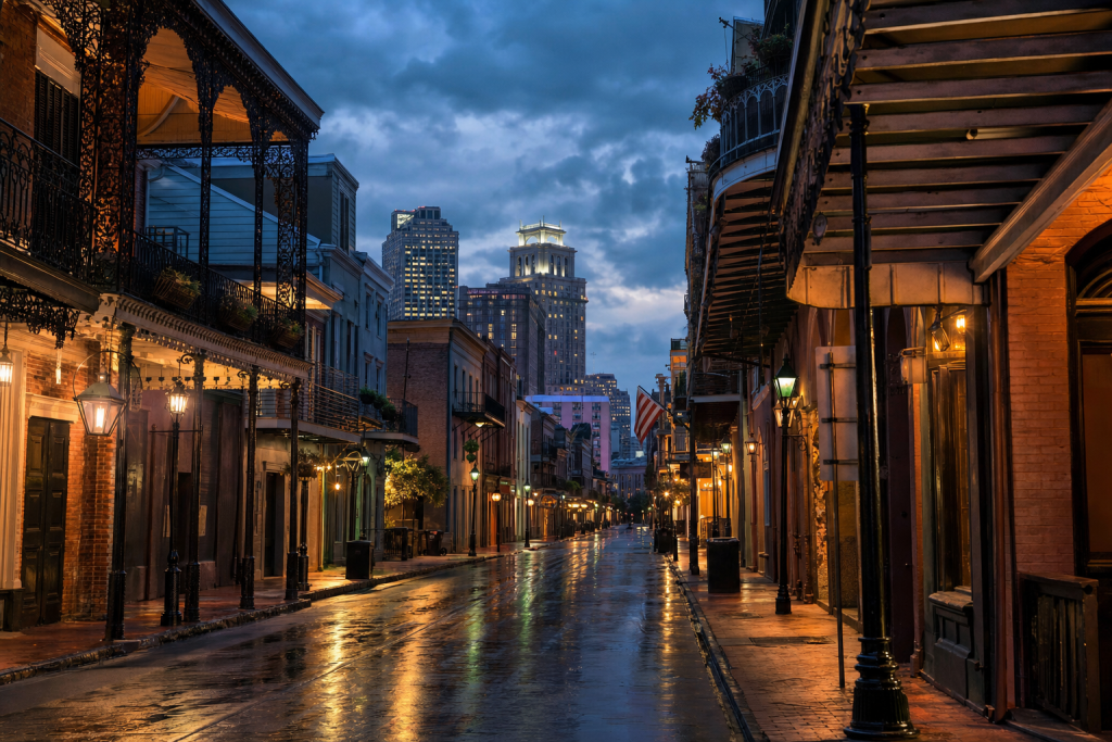 Street-level perspective in New Orleans, leading lines, architectural detail, blue hour with mixed ambient and street
