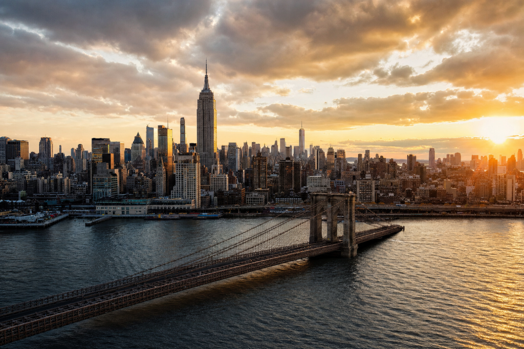 New York City at golden hour, iconic landmarks visible, dramatic warm light