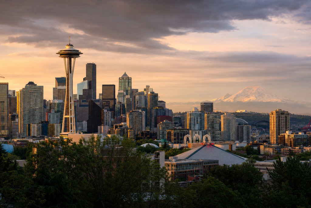 Seattle at golden hour, iconic landmarks visible, dramatic warm light