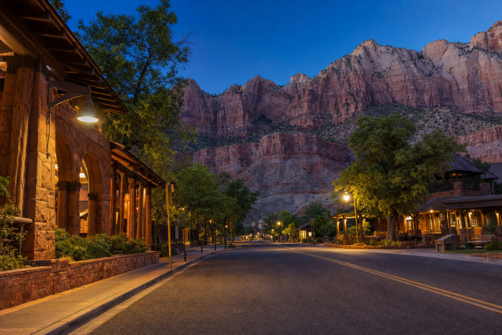 Street-level perspective in Zion, leading lines, architectural detail, blue hour with mixed ambient and street lighting