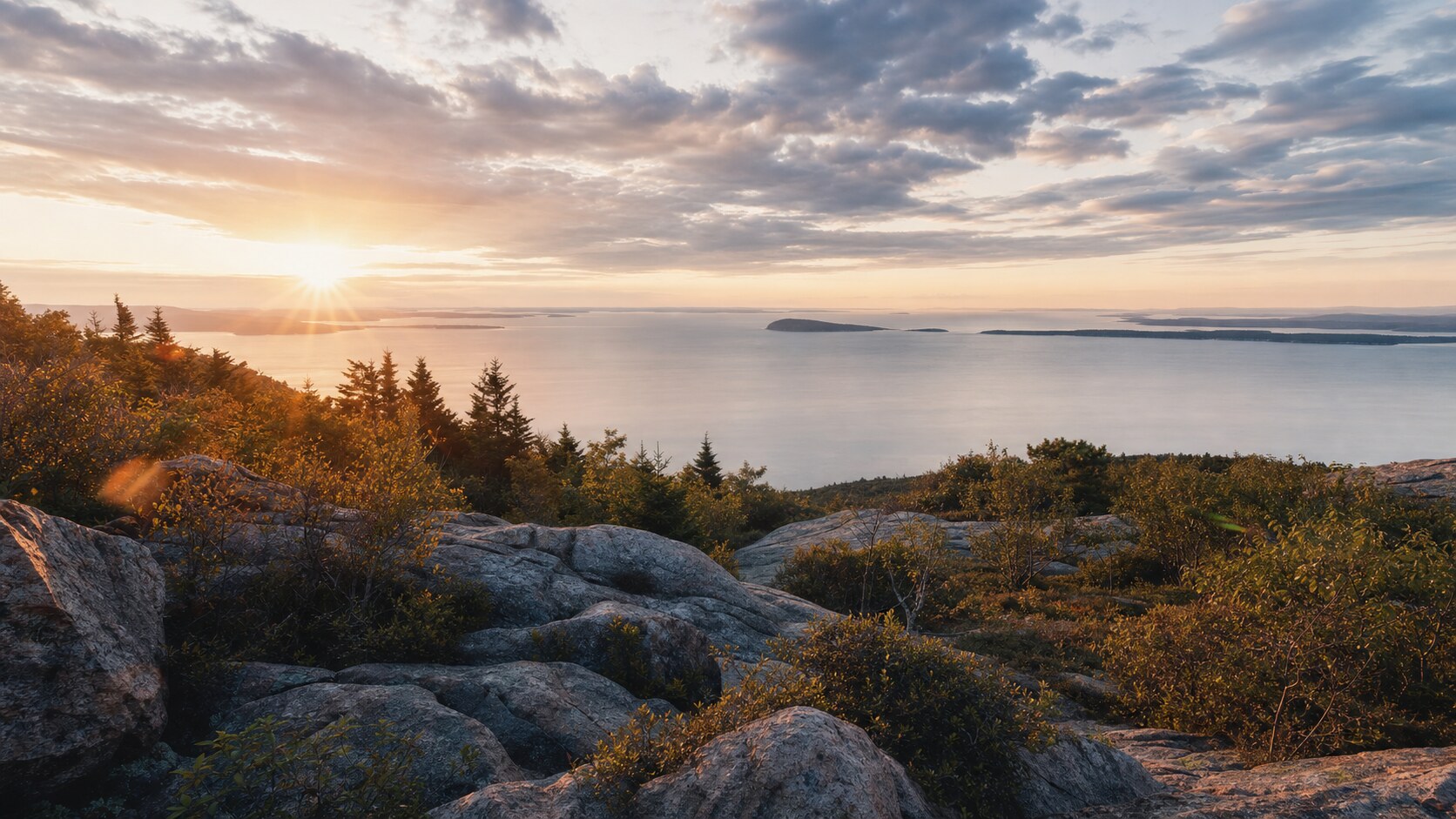 Sunrise landscape photograph at Acadia National Park from the most popular sunrise overlook, showing the signature foreground-to-background composition