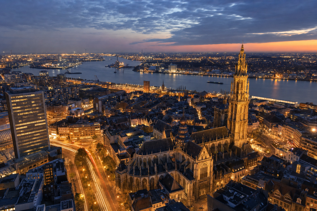 Antwerp high-vantage cityscape at blue hour with city lights and traffic motion