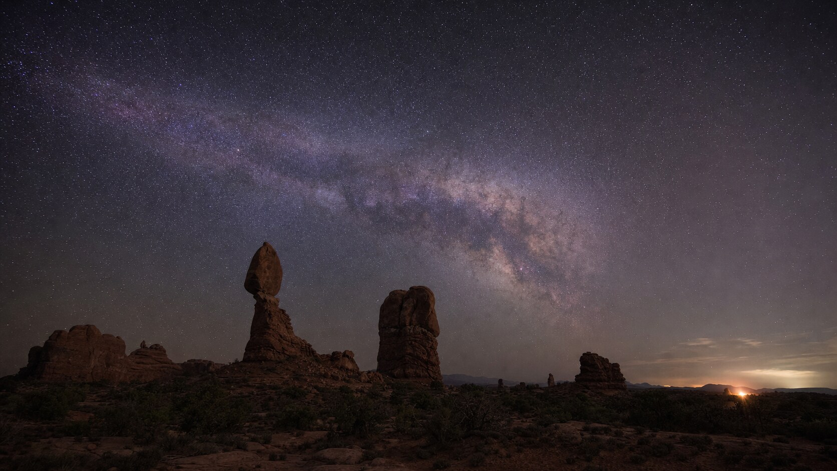Milky Way and night sky over the iconic landmark of Arches National Park — a classic astrophotography composition for the park