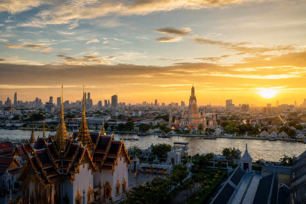 Bangkok skyline at golden hour with iconic landmarks in warm light