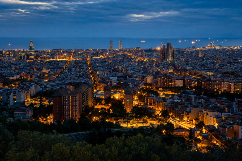 Barcelona high-vantage cityscape at blue hour with city lights and traffic motion