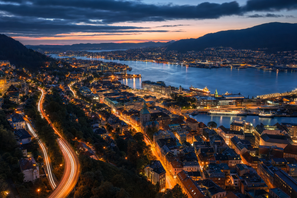 Bergen high-vantage cityscape at blue hour with city lights and traffic motion