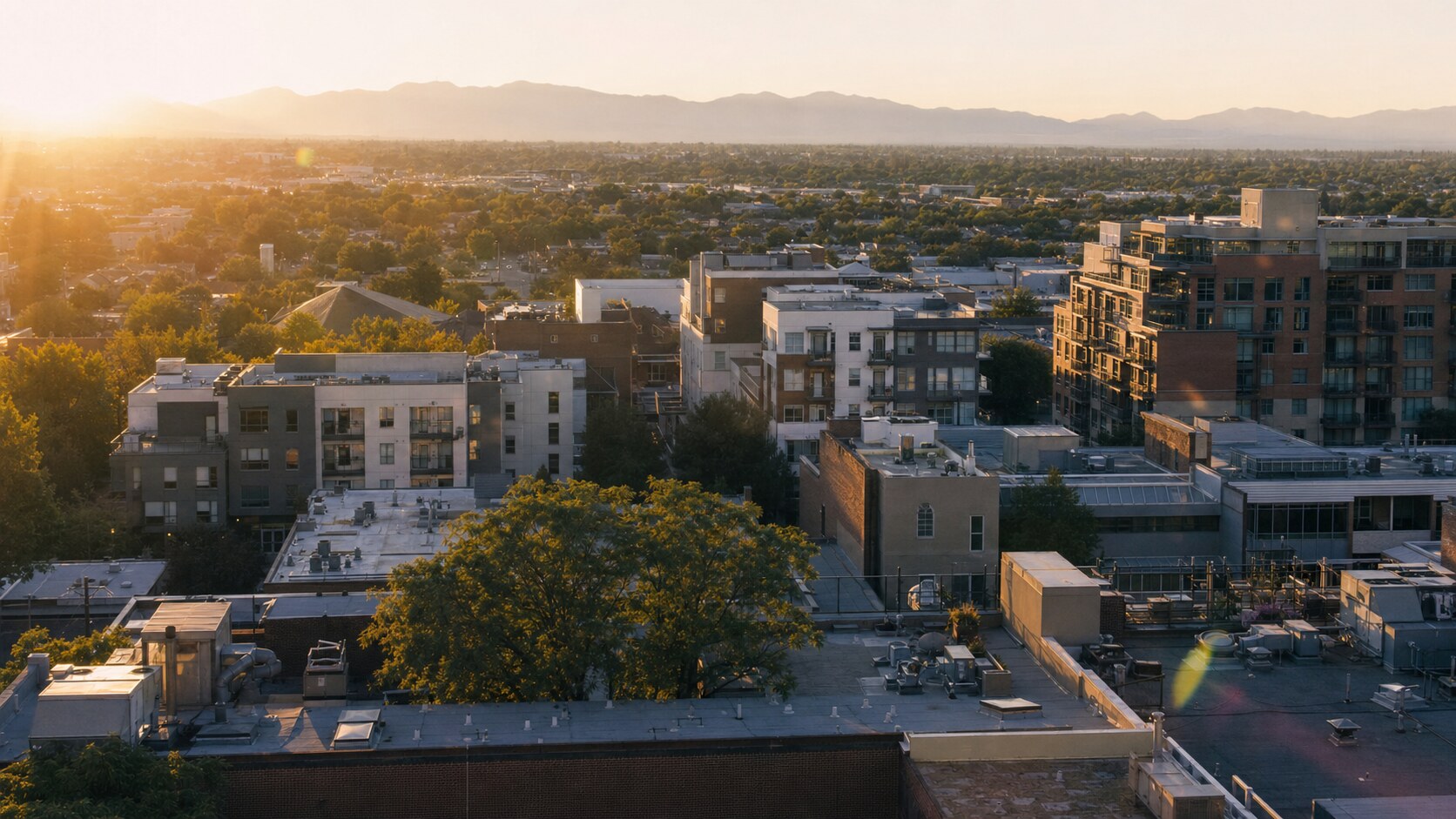 Elevated rooftop view of Capitol Reef at golden hour, showing layered urban density and natural shadow direction