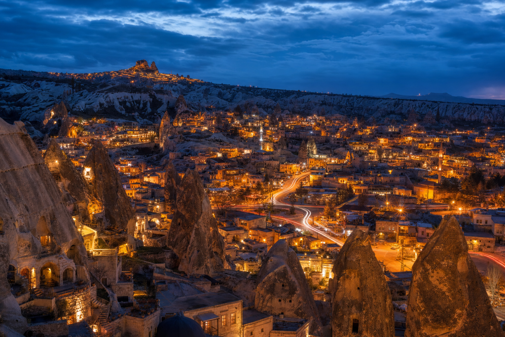 Cappadocia high-vantage cityscape at blue hour with city lights and traffic motion