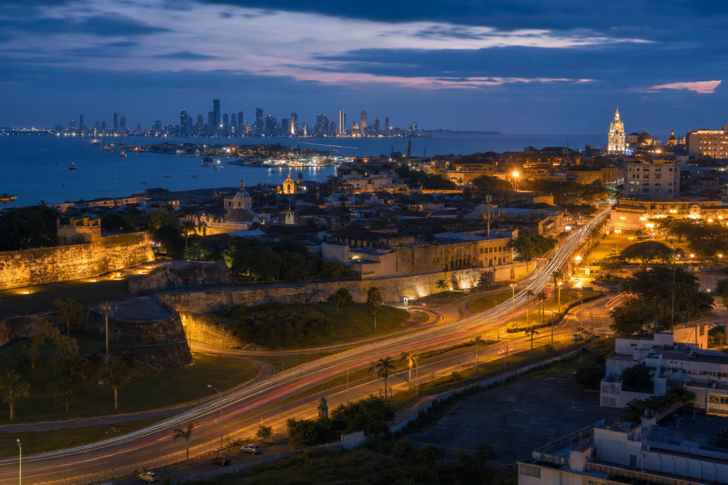 Cartagena high-vantage cityscape at blue hour with city lights and traffic motion