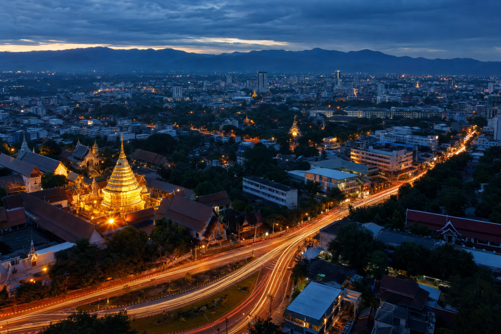 Chiang Mai high-vantage cityscape at blue hour with city lights and traffic motion