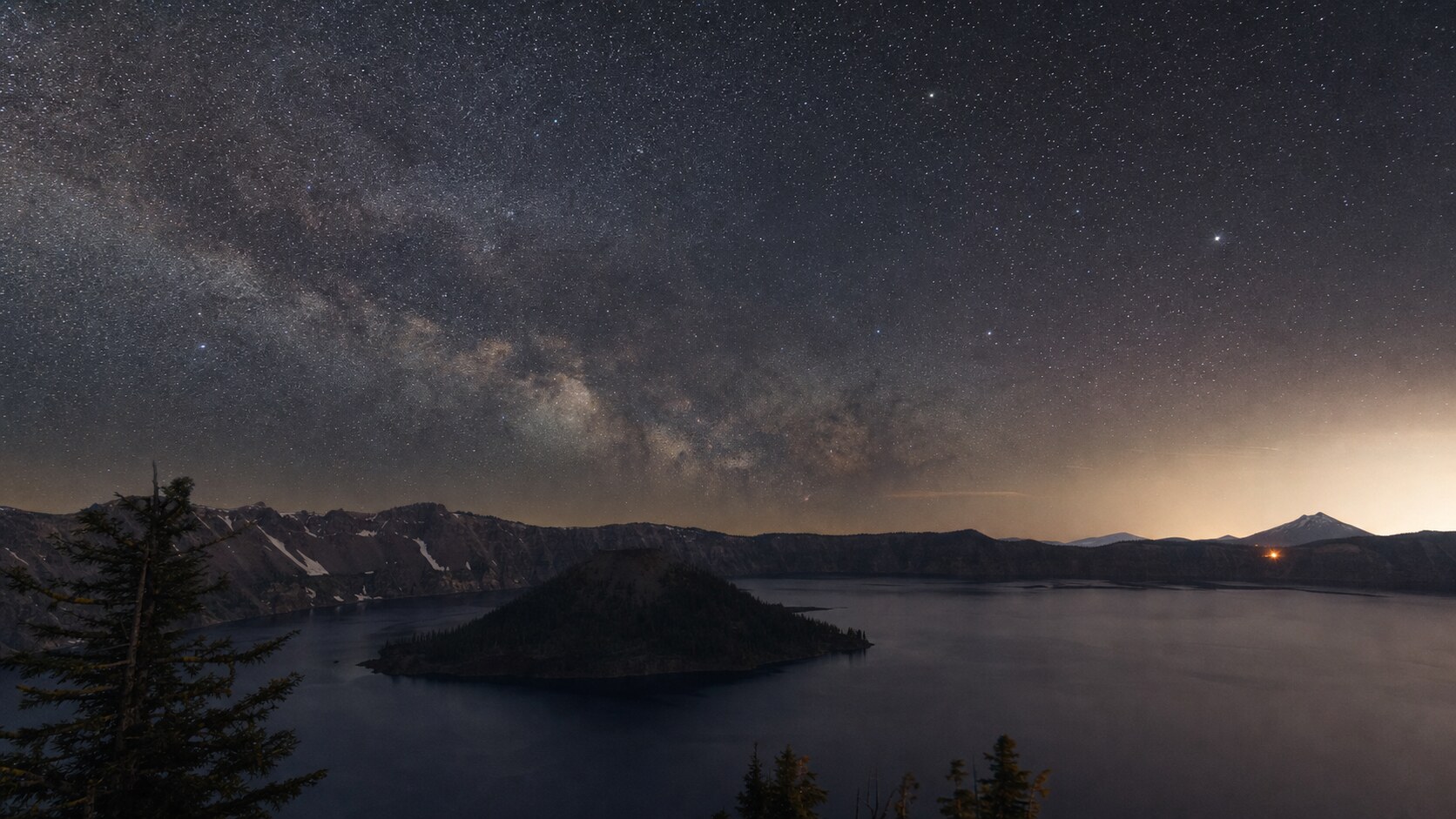 Milky Way and night sky over the iconic landmark of Crater Lake National Park — a classic astrophotography composition for the park